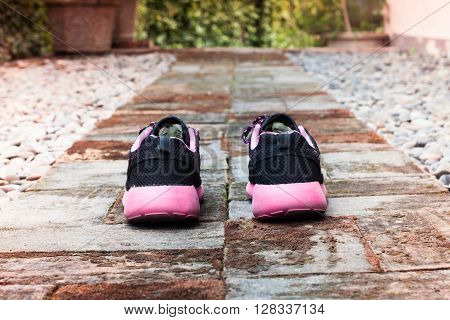 Running shoes in home garden foot path, stock photo