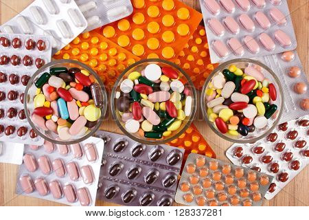 Colorful medical pills and capsules for therapy and blisters of tablets or supplements concept of treatment and health care