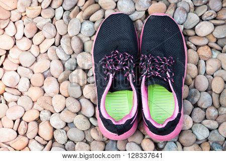 Running shoes in home garden on pebbles, stock photo