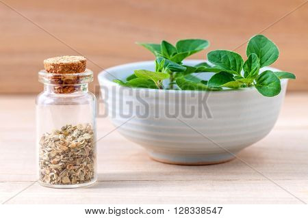 Fresh Oregano And Oregano Dried In A The Bottle With Shallow Depth Of Field Setup On Wooden Backgrou