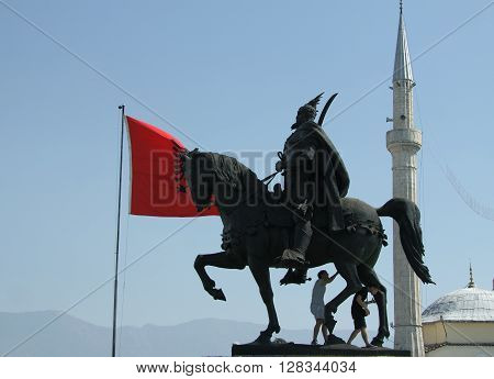 Skanderbeg's monument Tirana Albania Albanian national flag flying Ethem Bey Mosque minaret in the background
