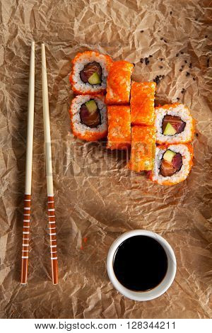 Maki Sushi with Masago  - Roll made of Fresh Raw Salmon, Avocado inside. Masago (smelt roe) outside