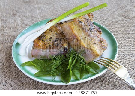 a plate of steak and fresh herbs