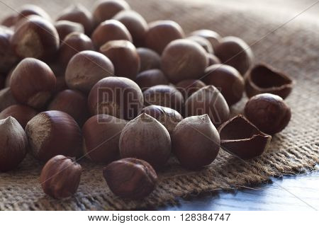 Hazelnuts on burlap on the table. Horizontal shot.
