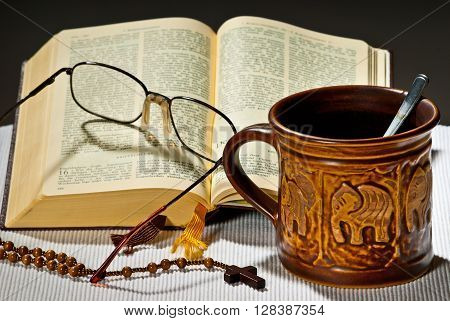 still life with cup of tea and open bible