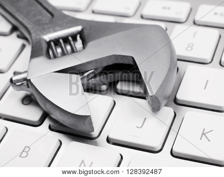 IT Support. Forceps on a computer keyboard.