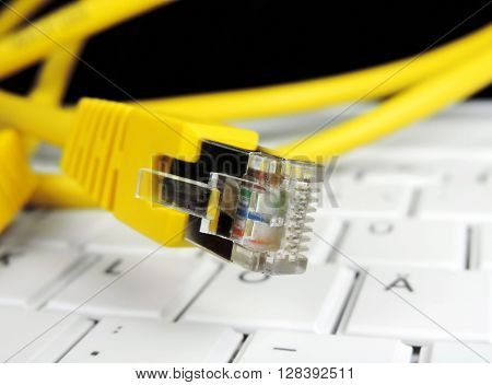 High speed internet connection. Computer cable on a computer keyboard.