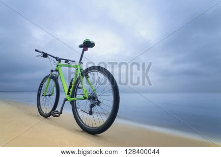 Bike on the bank of the beach, early spring