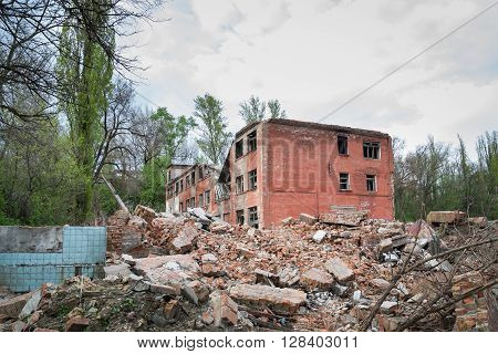 Demolition of buildings in urban environments. House in ruins.