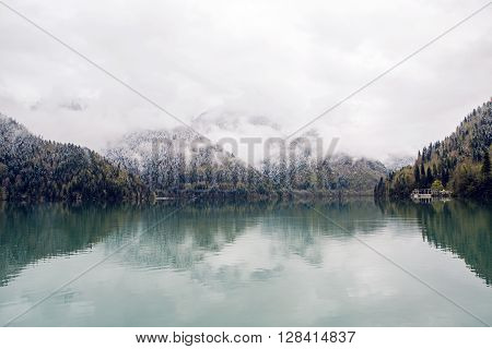 panorama left-to-right Ritsa lake in the spring morning, with clouds and blue water