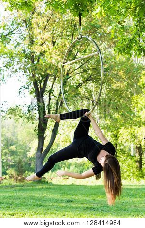 beautiful girl on the hoop on nature background
