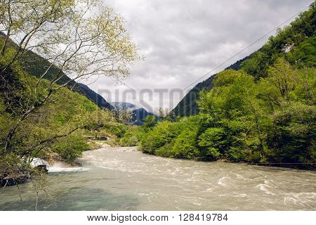 rapid mountain river in Abkhazia in the spring morning, with mountains