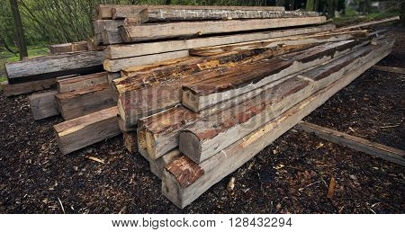 Wooden beams. Perspective composition with long beams. Exterior scene with building material. Roof building wooden components. Carpentery beam.