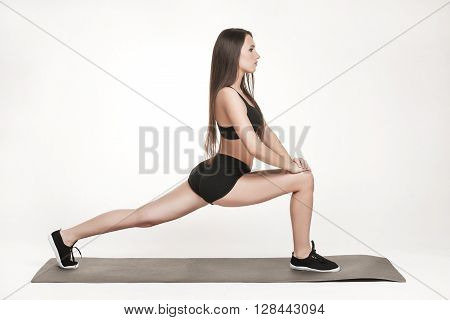 Portrait of young attractive woman doing exercises. Brunette with fit body on yoga mat. Healthy lifestyle and sports concept. Series of exercise poses.