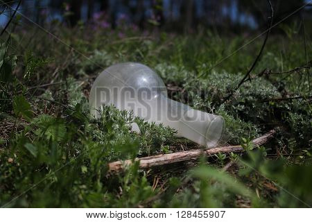 retort with effluent smoke in a green grass