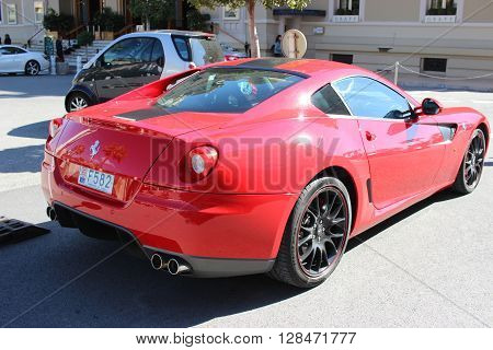 Monte-Carlo Monaco - March 9 2016: Red Ferrari 430 Scuderia (rear view) Parked in Front of the Monte-Carlo Casino in Monaco