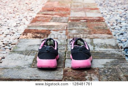 Running shoes in home garden foot path, stock photo