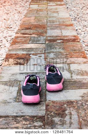 Running shoes in home garden foot path, stock photo