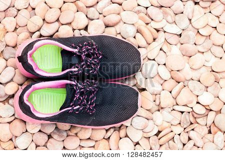 Running shoes in home garden on pebbles, stock photo