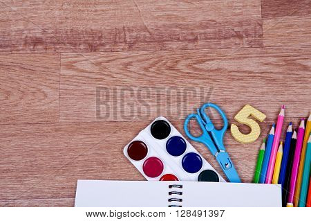 Many different school accessories on wooden background