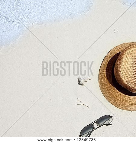 Fedora Hat And Sunglasses Are Washed Away By A Wave. Relaxation Or Vacation Concept