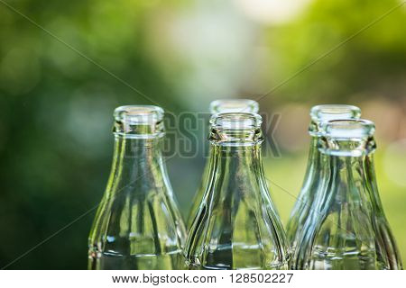 Glass Bottles Over The Sunny Background