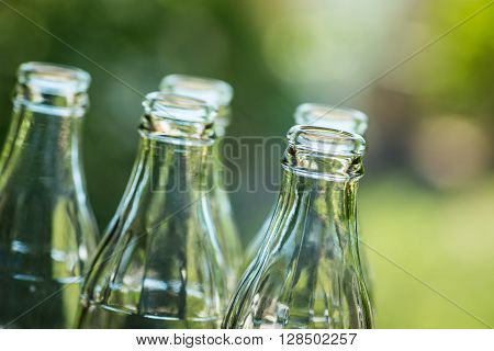 Glass Bottles Over The Sunny Background
