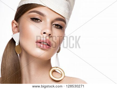 Pretty fresh girl in the image of modern Twiggy in fashionable white hat, with unusual eyelashes and accessories. Photos shot in studio
