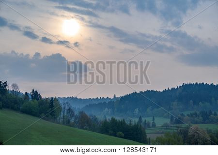 Hazy morning  above Solina lake shore (Bieszczady mountains, Poland), in the beginning of May