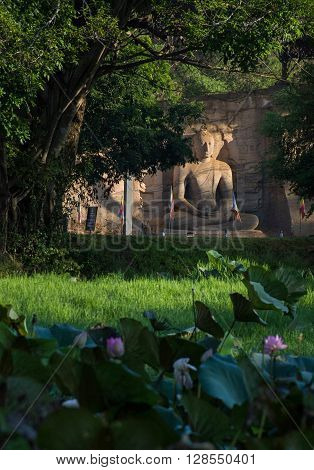 POLONNARUVA, SRI LANKA - May 01 2016: Buddha statue face on yellow stone wall at Gal Vihariya on May 01 2016 in Polonnaruwa, Sri Lanka