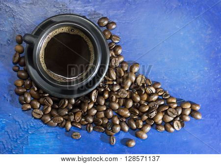A cup of hot coffee on the old blue background