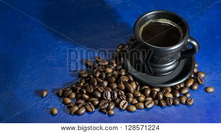 A cup of hot coffee on the old blue background