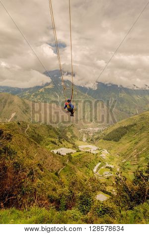 Silhouette Of Young Caucasian Man On A Swing called Flight of the Condor Banos de Agua Santa Ecuador