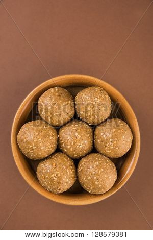 The indian sesame sweet or tilgul laddu, made up of jaggery and sesame seeds, hand made, round, indian sweet prepared in Makar Sankranti festival,