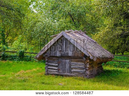 Ancient traditional Ukrainian barn with a straw roof. Rural concept.