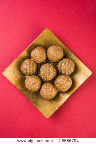 The indian sesame sweet or tilgul laddu, made up of jaggery and sesame seeds, hand made, round, indian sweet prepared in Makar Sankranti festival,