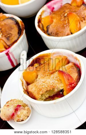 Clafoutis with raspberry jam and peach slice summer dessert selective focus