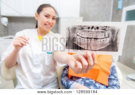 Dentist looking at x-ray picture in the office