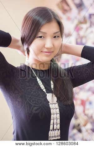 Beautiful Chinese girl wears a national Yakut ornaments of silver.