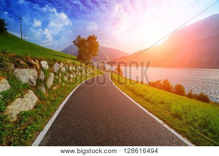 Beautiful view of the bike road on lake Resia, Alps, Italy, Europe.