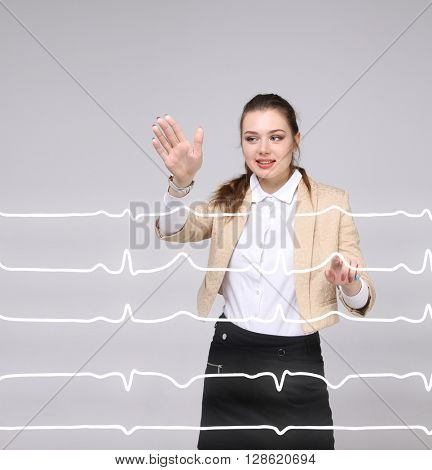 Doctor woman working with cardiogram lines