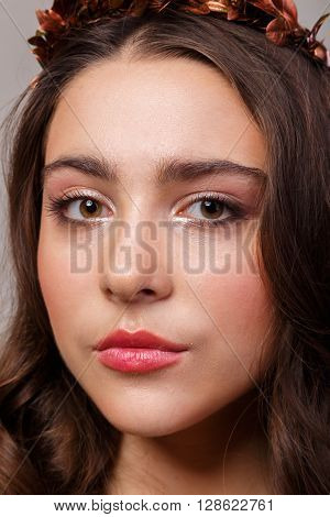 Portrait of a gorgeous brunette on a light background. Chic hair eyes and eyebrows.