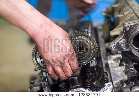 Hands Repairing A Car Engine With A Wrench