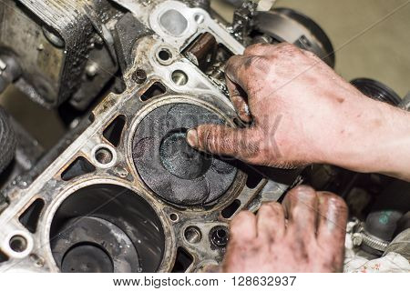 Hands Repairing A Car Engine With A Wrench