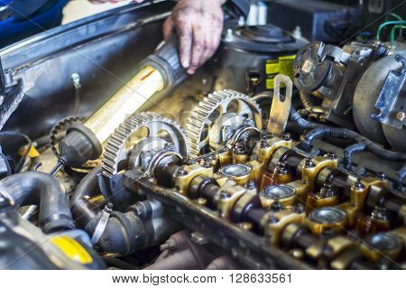 Hands Repairing A Car Engine With A Wrench