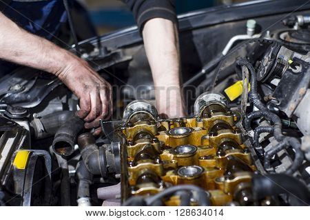 Hands Repairing A Car Engine With A Wrench
