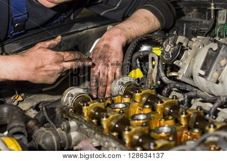 Hands Repairing A Car Engine With A Wrench