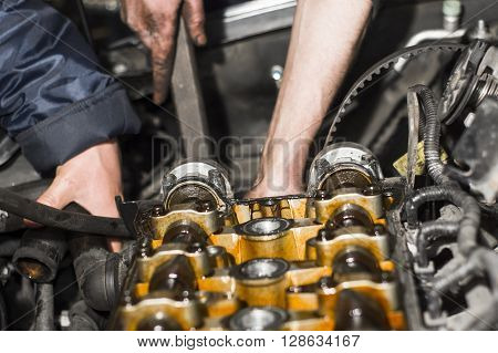 Hands Repairing A Car Engine With A Wrench