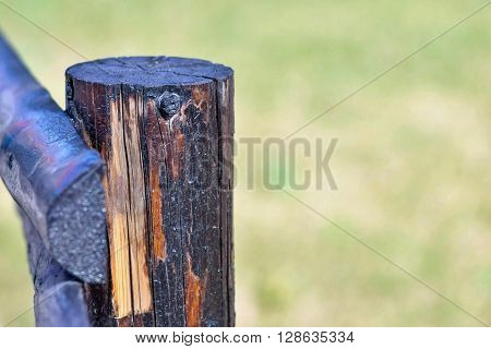 part of an old column from a wooden fence for the ranch closeup on an indistinct background