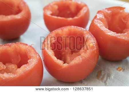 preparing tomatoes stuffed with rice with the removal of the pulp and the seeds